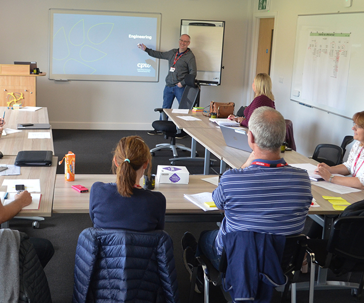 A group of people taking part in training in the Wiltshire Air Ambulance meeting room.