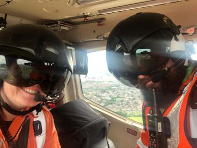 Critical care paramedics Jo Gilbert and James Hubbard take a selfie on-board the Wiltshire Air Ambulance helicopter wearing flight helmets and visors.