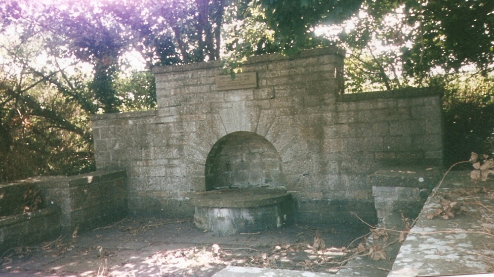 A photo of a stone holy well in Edington
