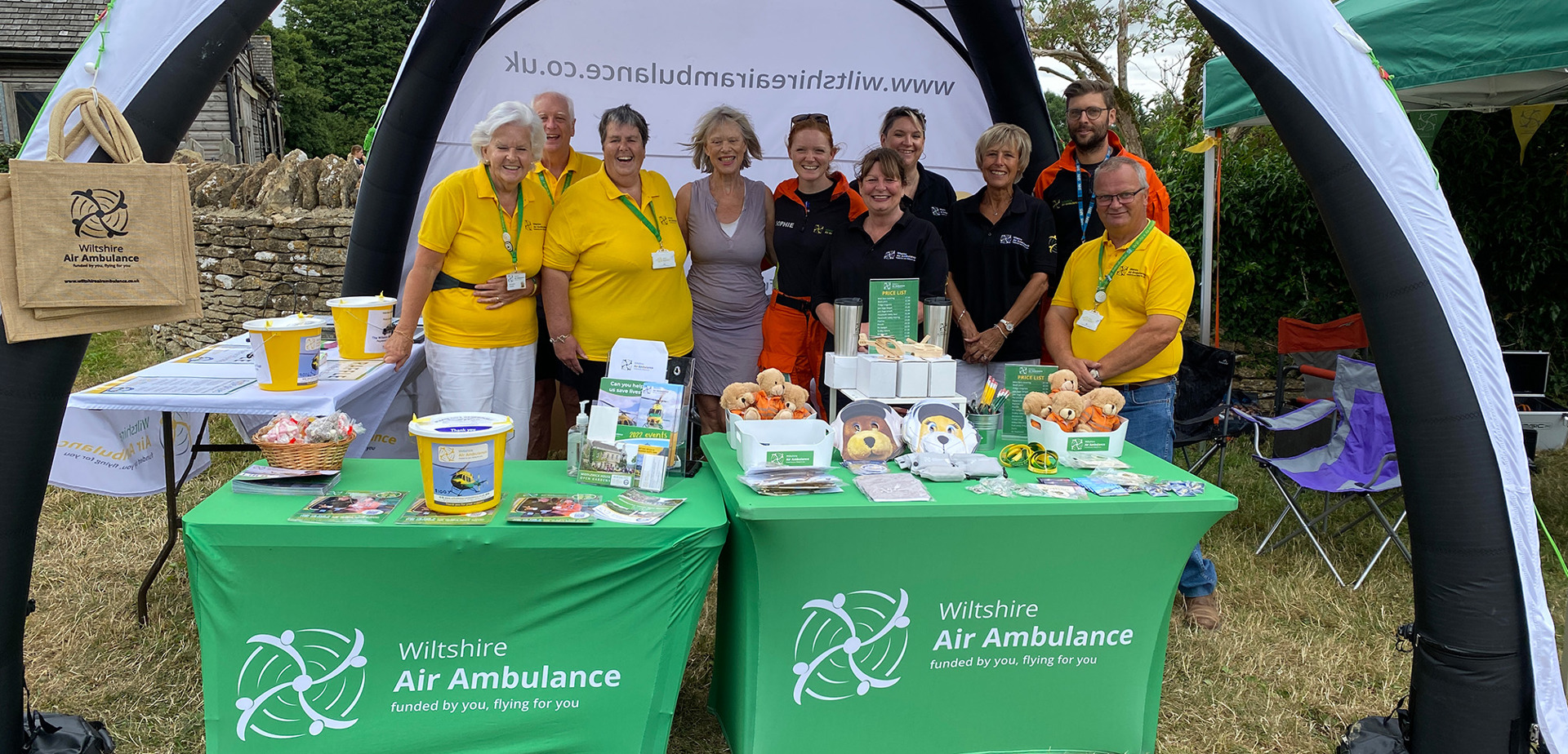 A group of volunteers, staff and aircrew at the Wiltshire Air Ambulance stall at Middlewick Open Gardens event