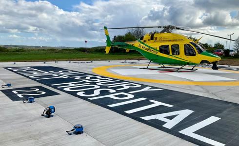 Yellow and green helicopter landed at Salisbury District Hospital's new helipad