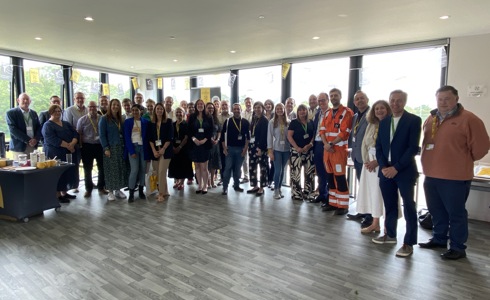 A large group of people smiling at the camera for the launch of The Business Club