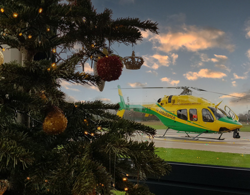 Christmas tree with helicopter in the background