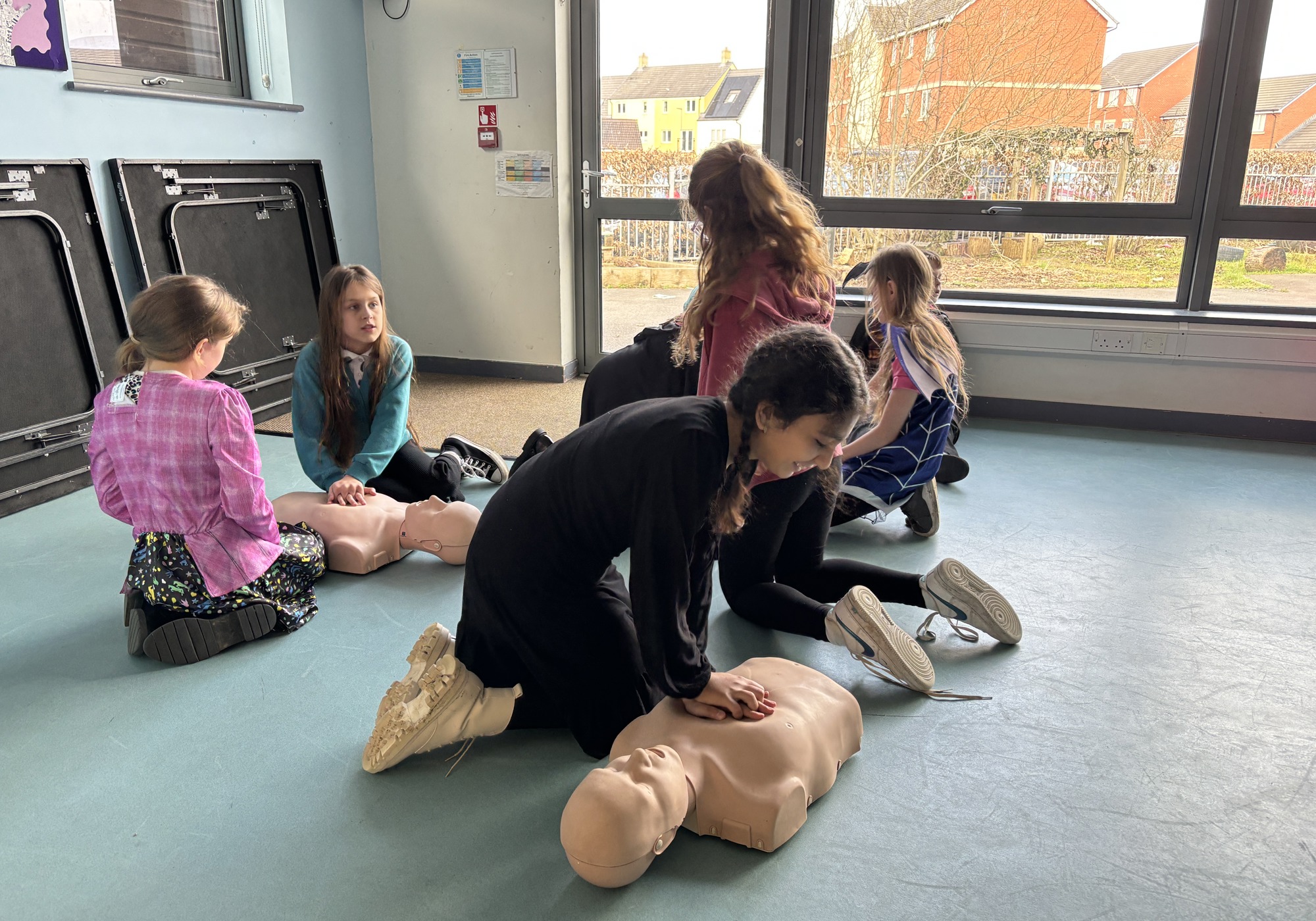 School girls practicing CPR